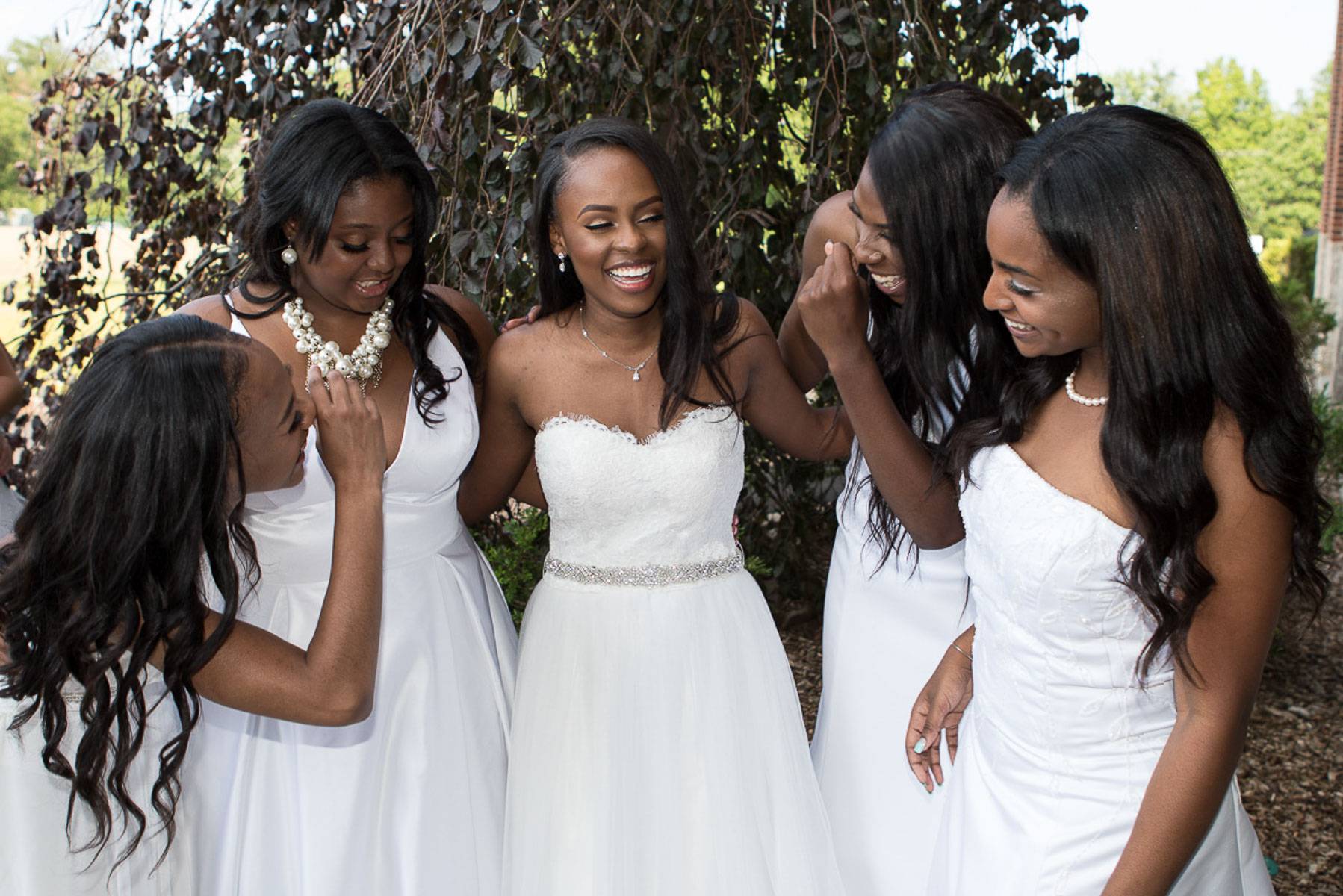 A group of women wearing white dresses