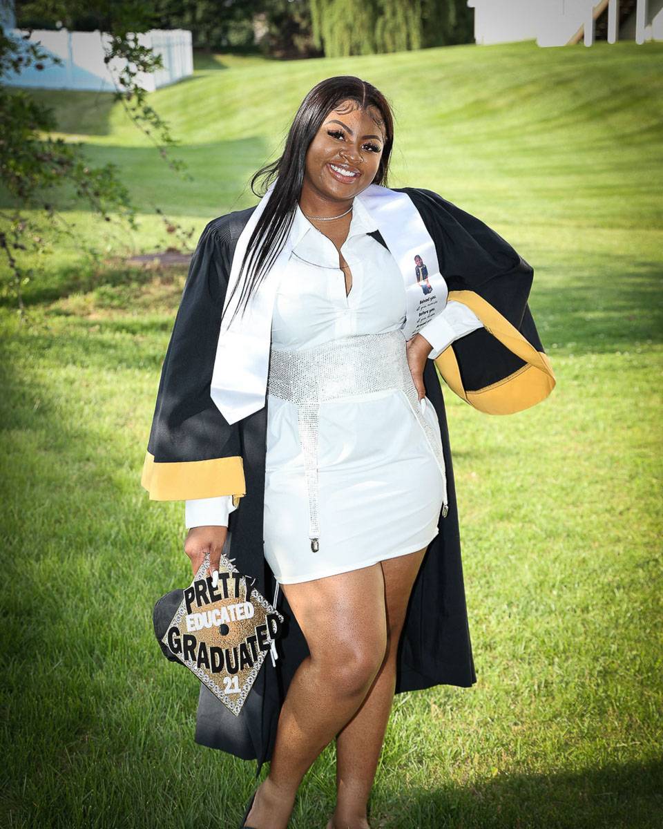 A woman wearing her graduation outfit