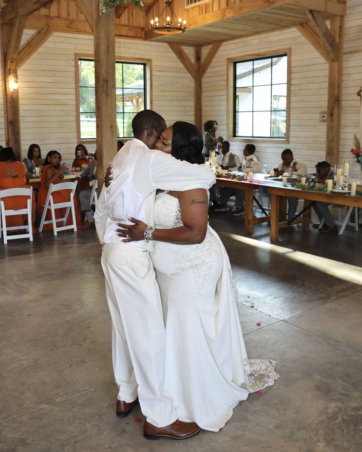 The bride and groom hugging