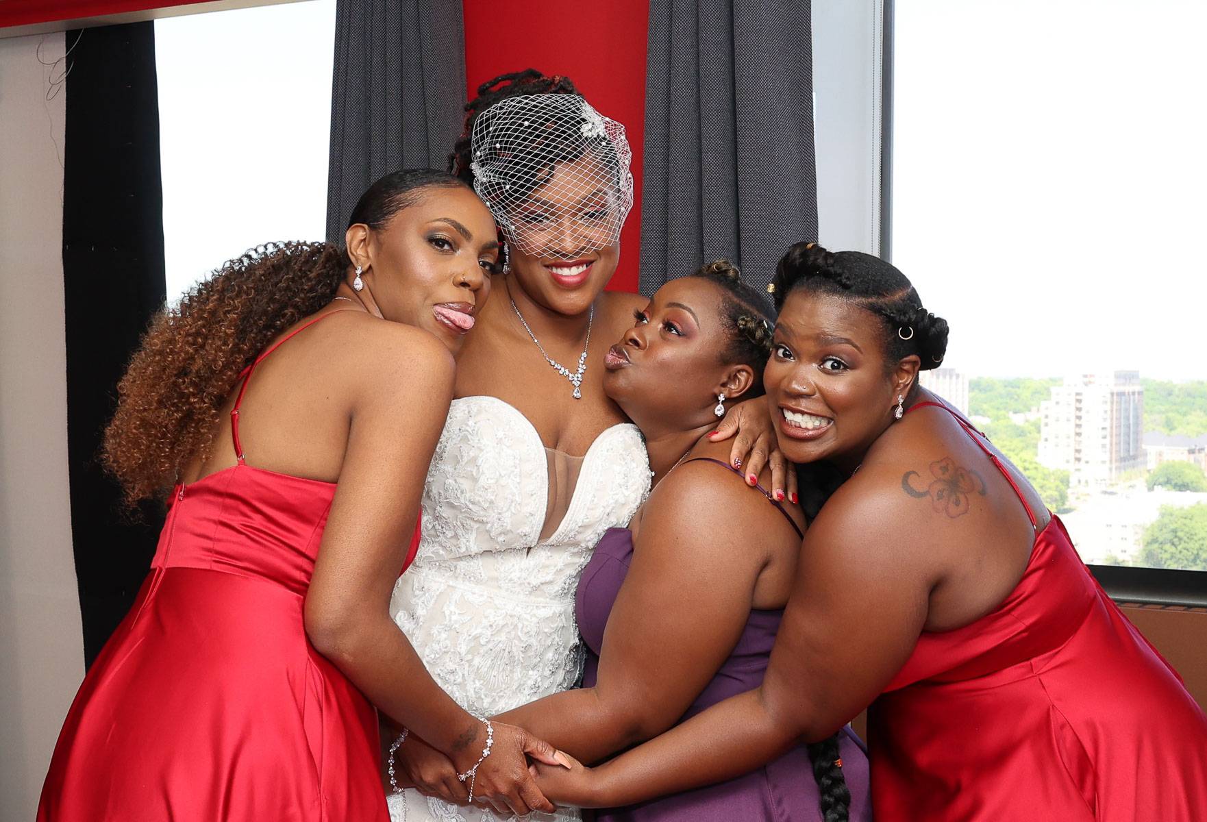 The bride and her three bridesmaids in a funny pose
