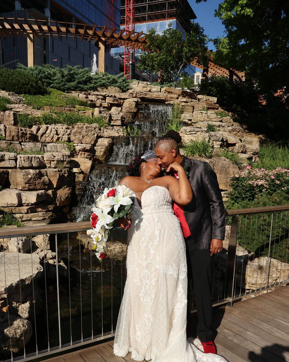 The newlyweds share a kiss on the bridge