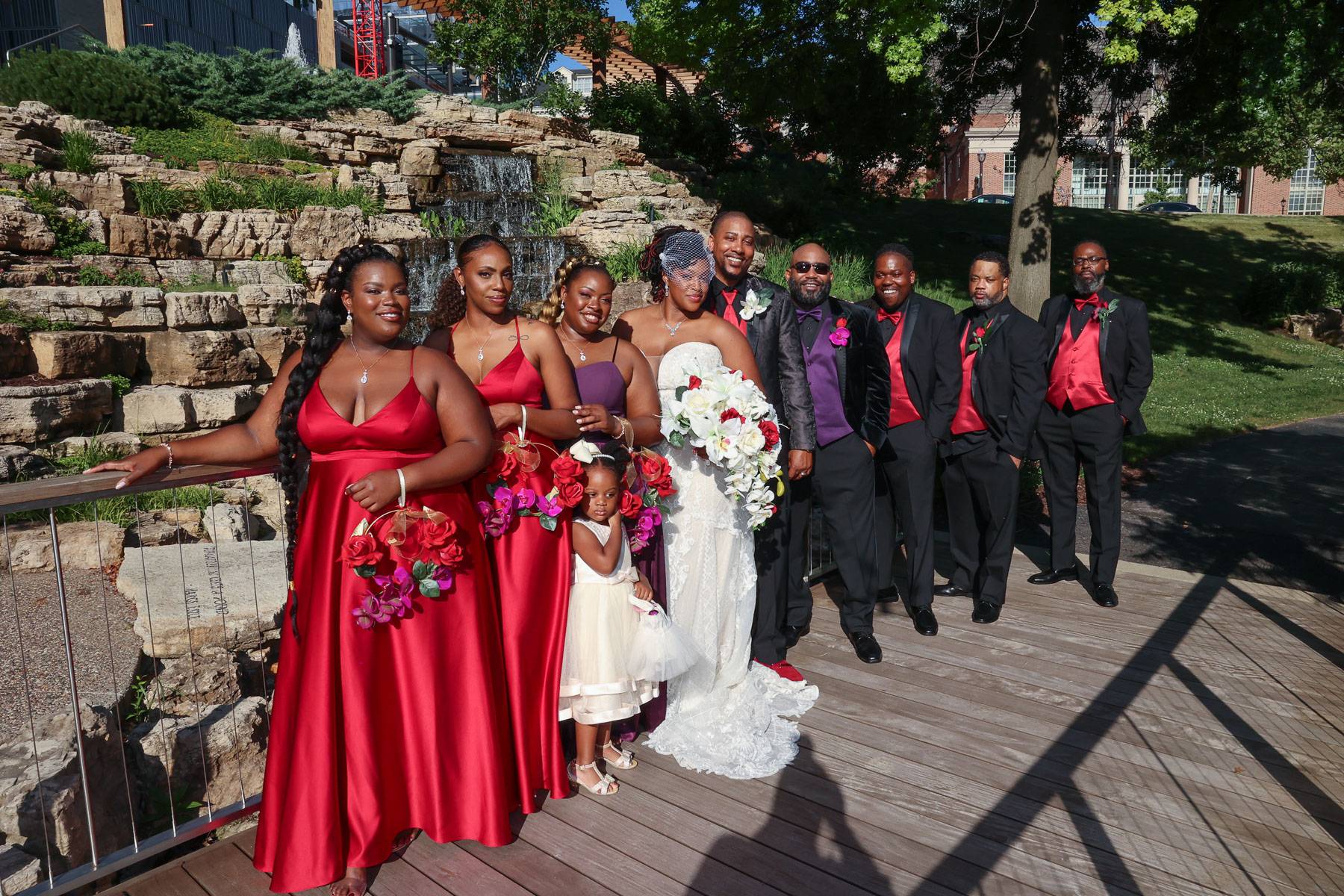The newlyweds and their attendants on a bridge