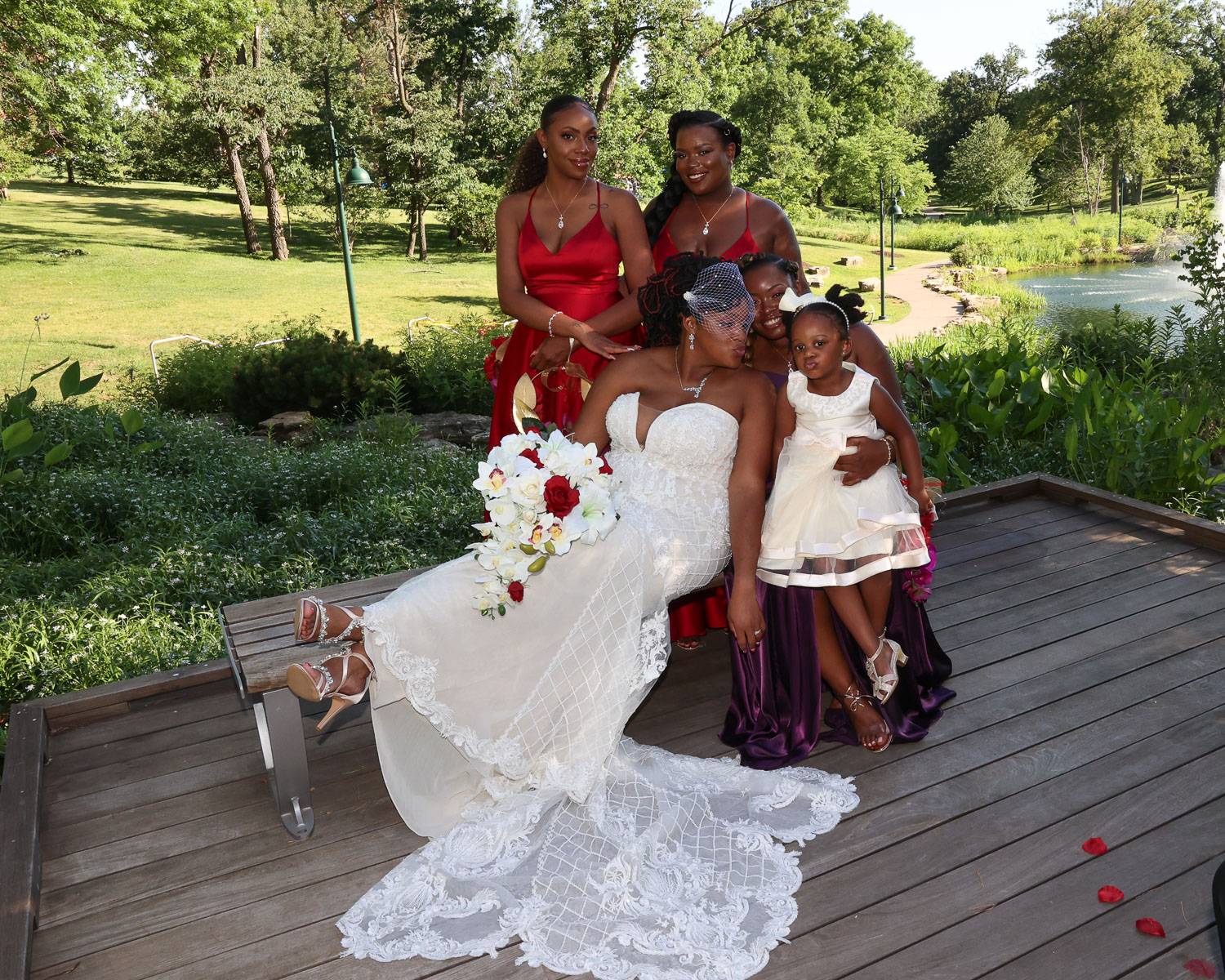 The bride happily sits with her attendants