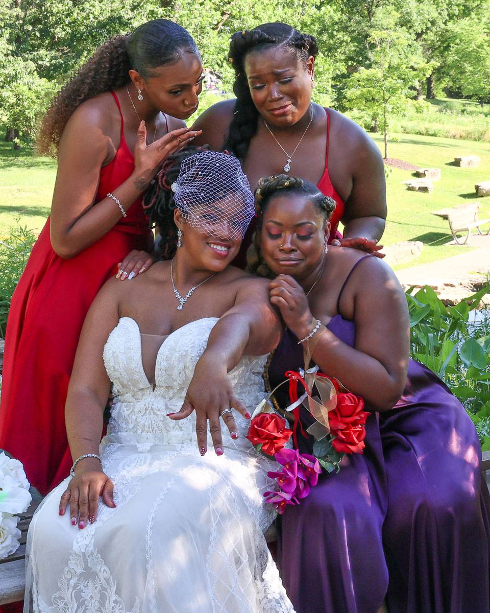 The bride showing the ring to her attendants