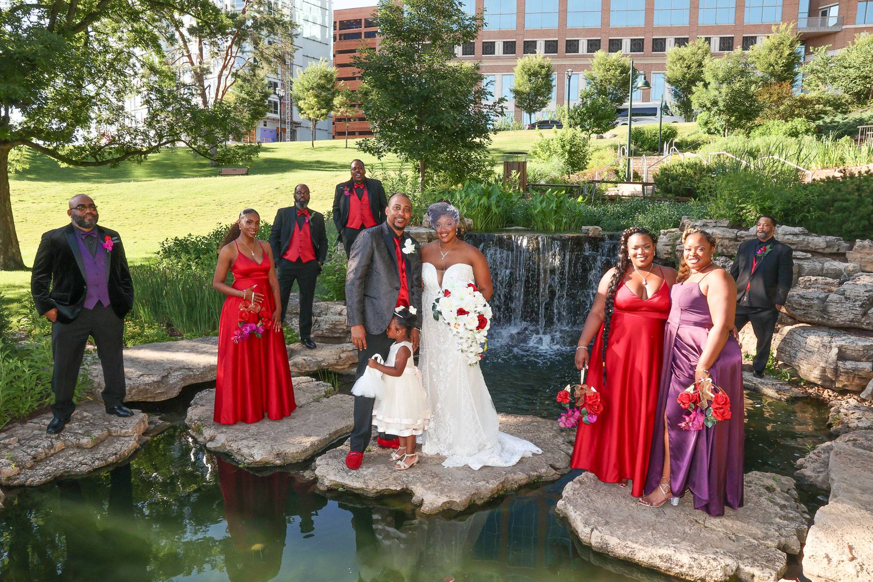 The newlyweds and their attendants at a pond
