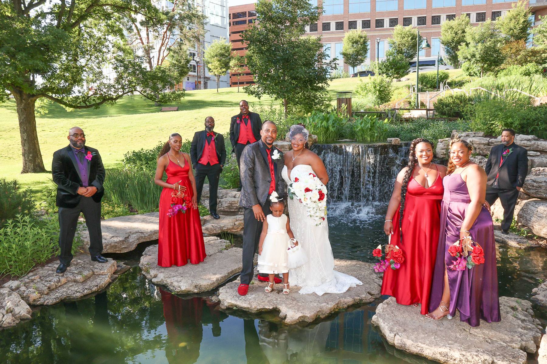 The newlyweds and their attendants at a pond and waterfall