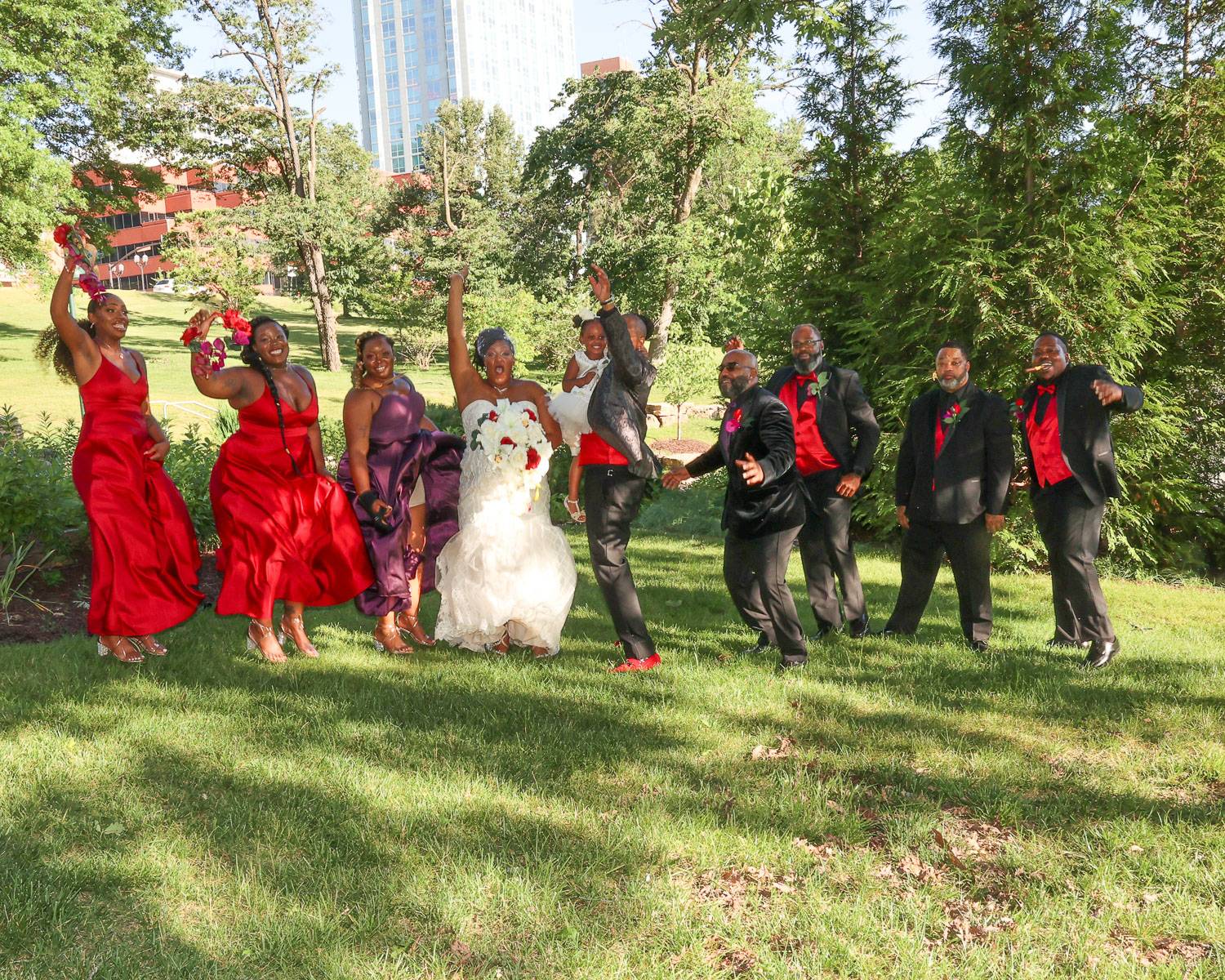 The newlyweds and their attendants jumping