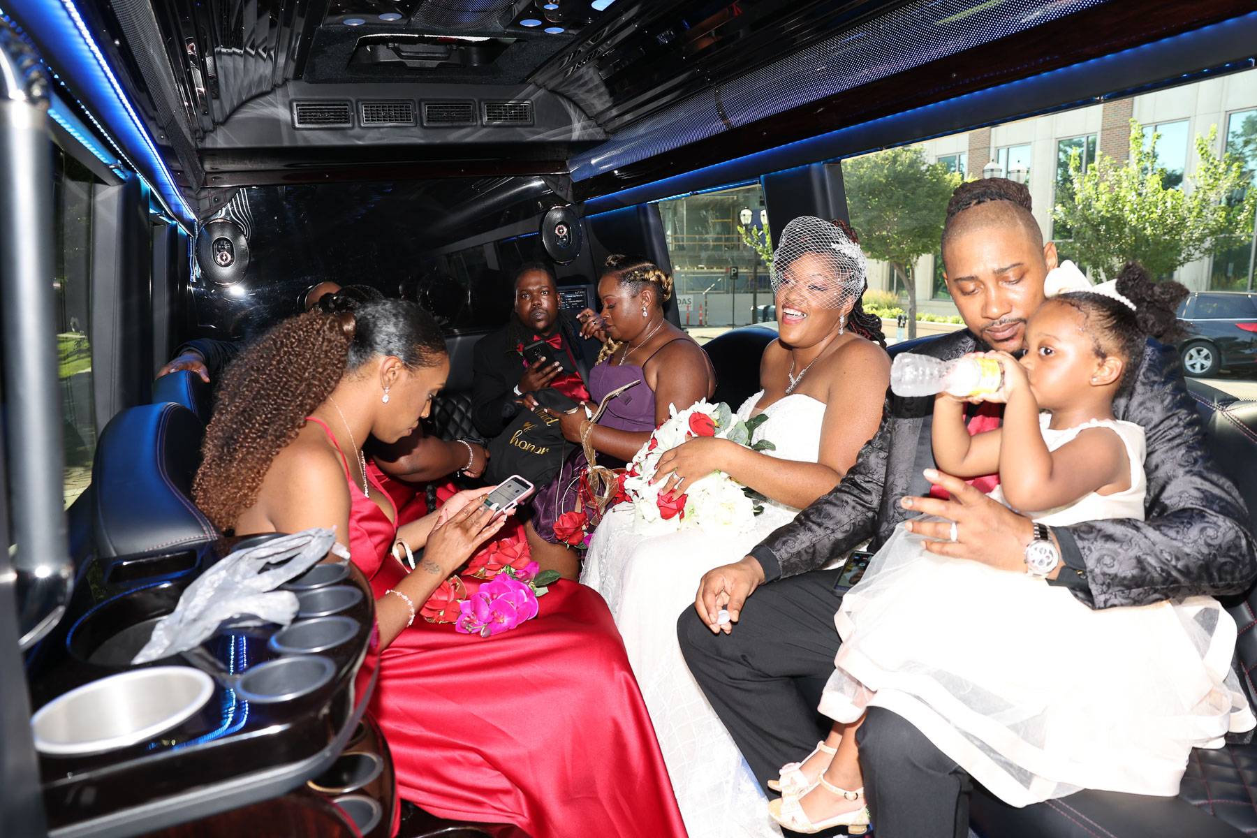 The newlyweds and their attendants inside a limo