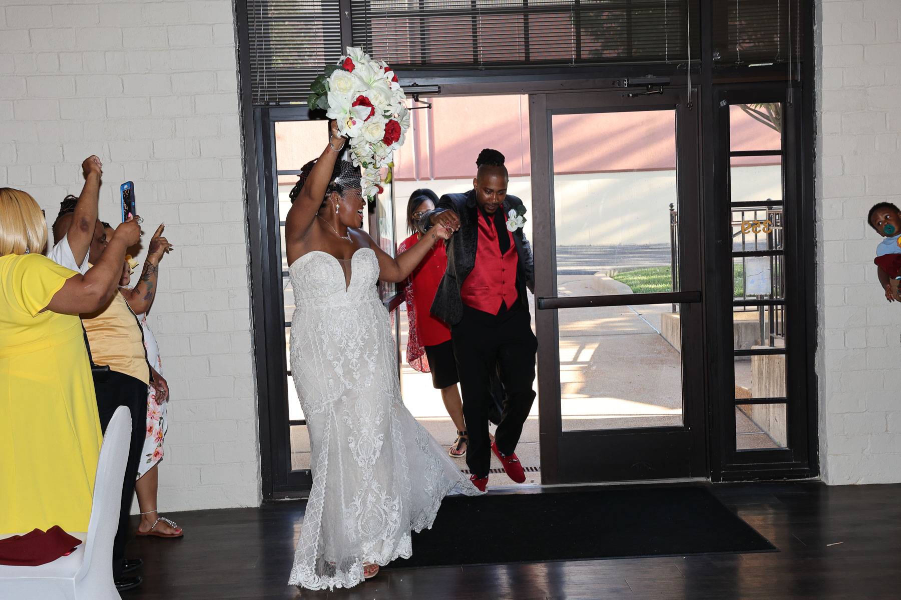 The bride leading the groom to the door