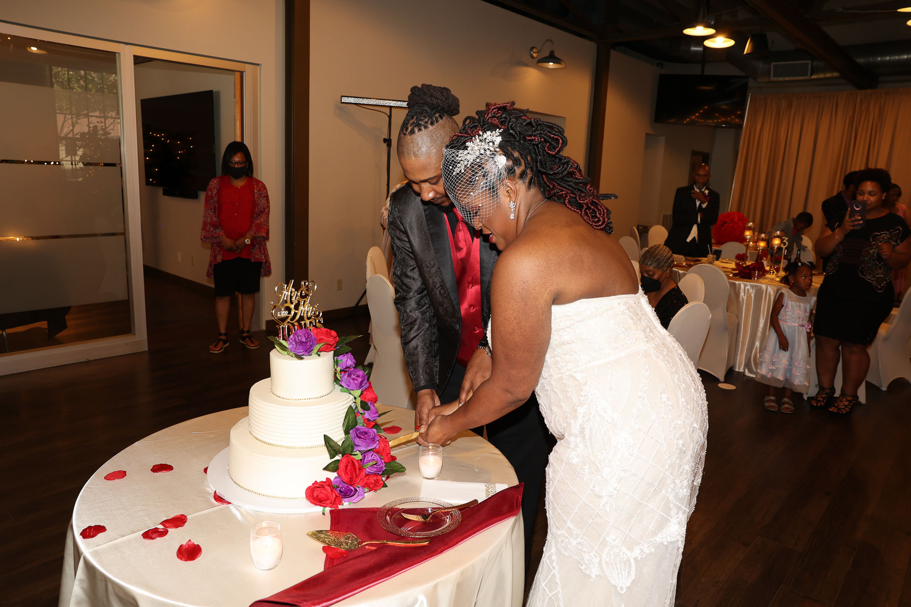 The newlyweds slicing the wedding cake
