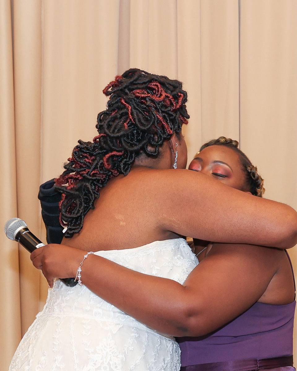 The bride and her friend hug