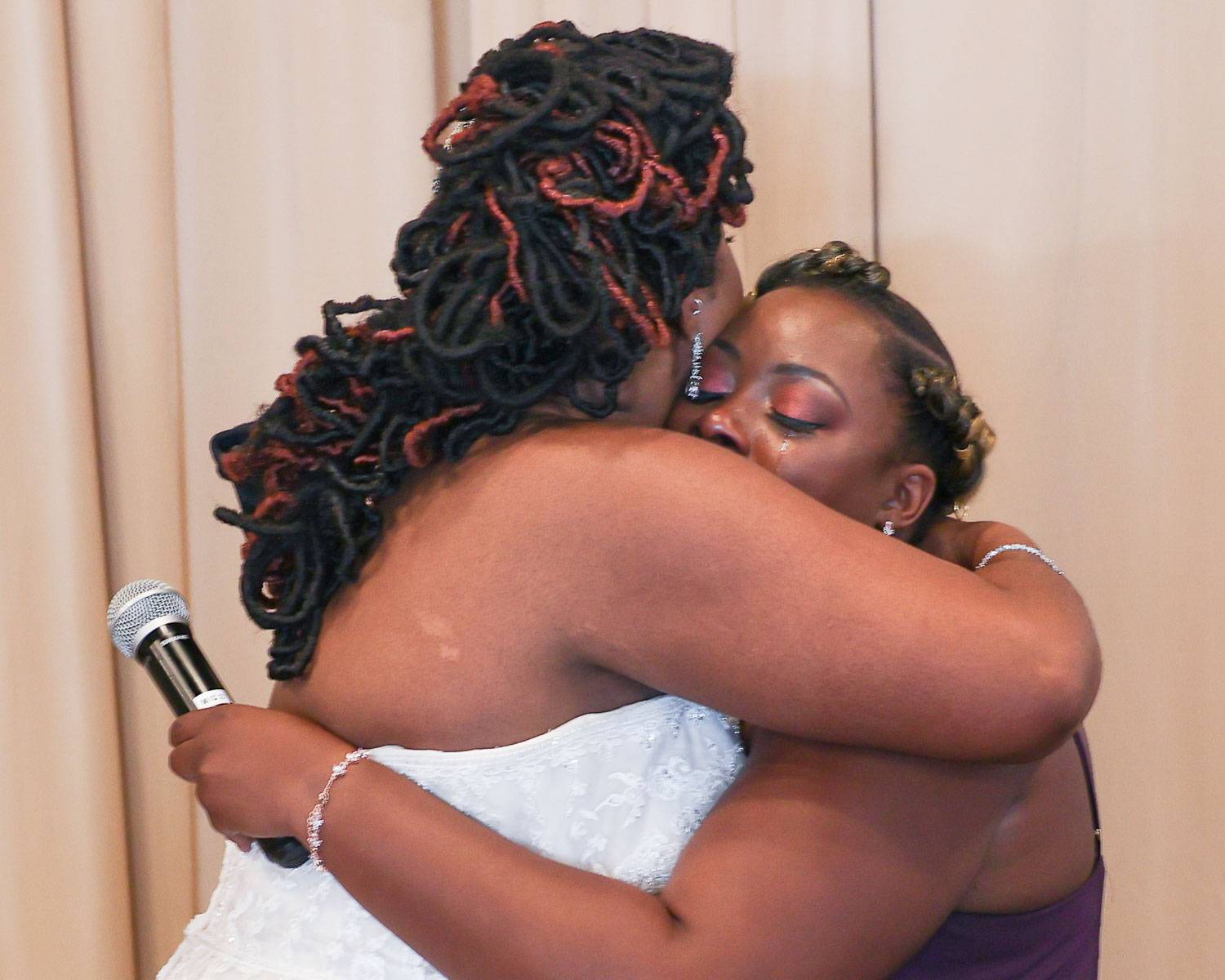 The bride and her friend hug