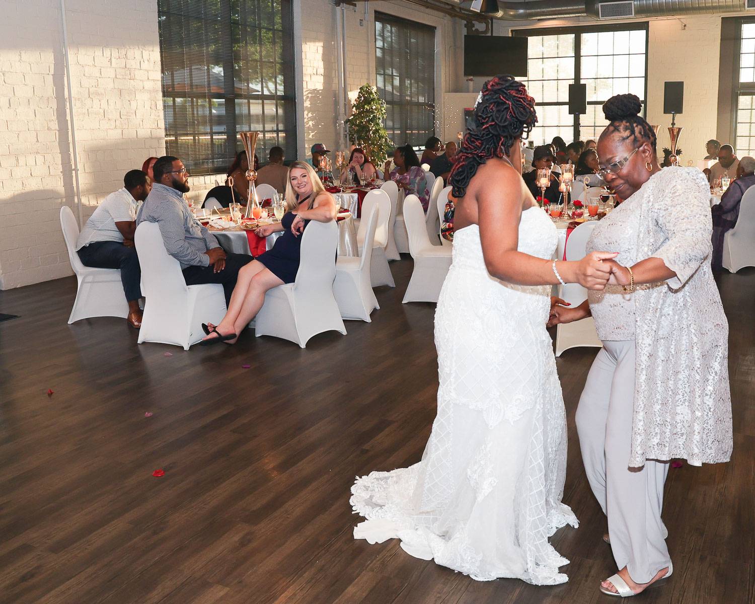 The bride dancing while holding hands with her mother-in-law