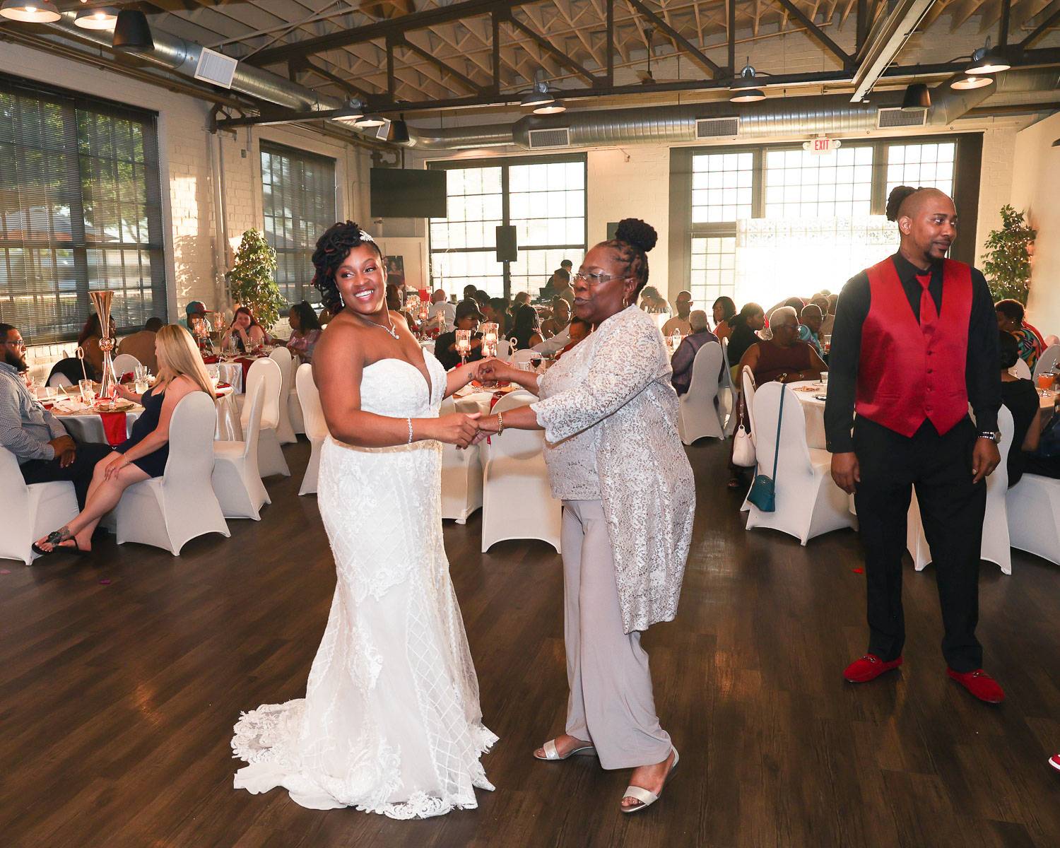 The bride and the mother-in-law dancing in the hall