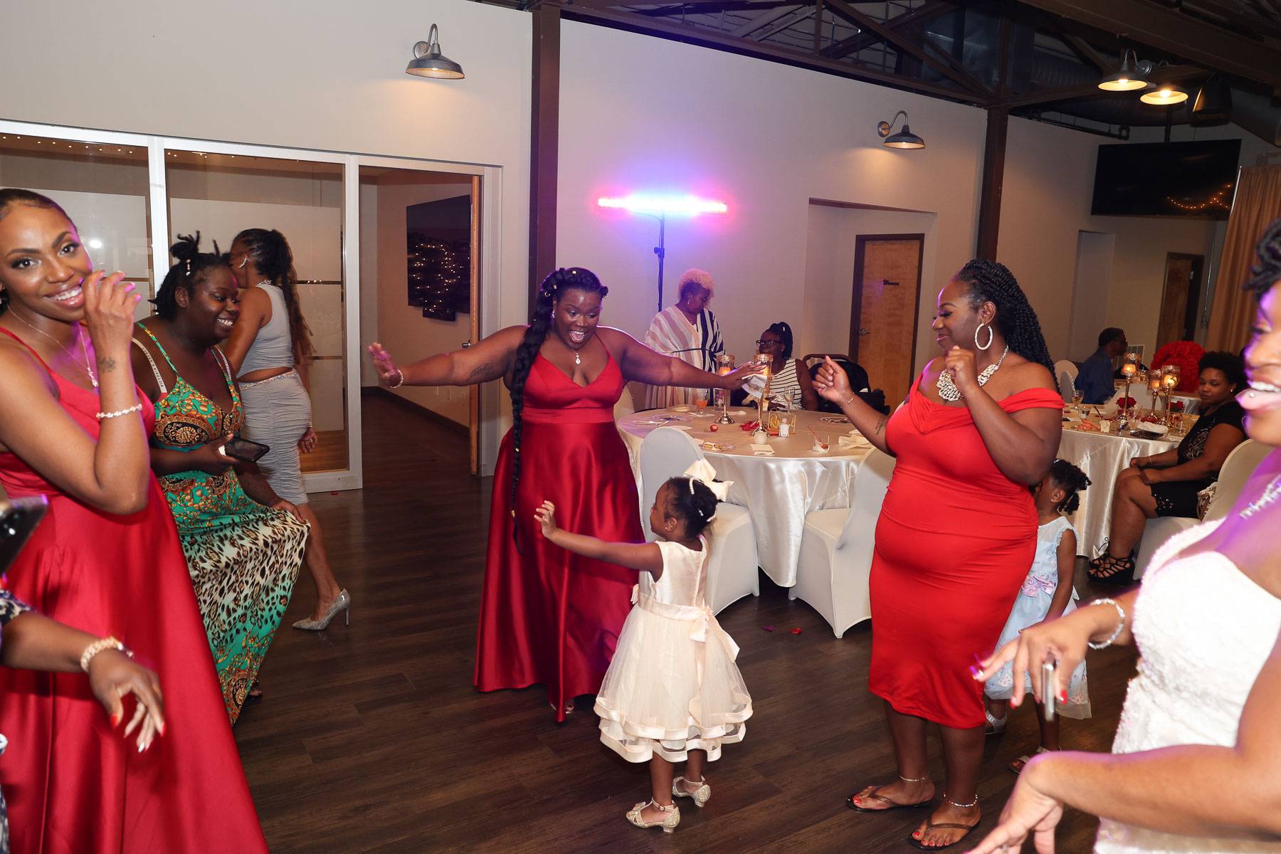 The bridesmaids dancing with the young girl