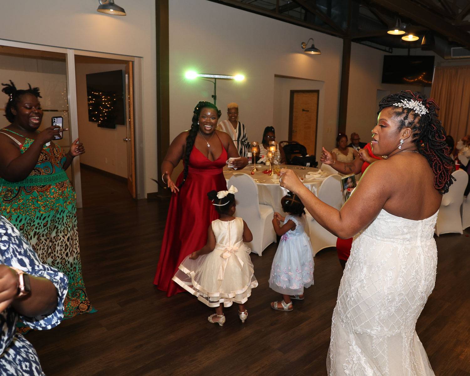Two young girls dancing with the bridesmaids