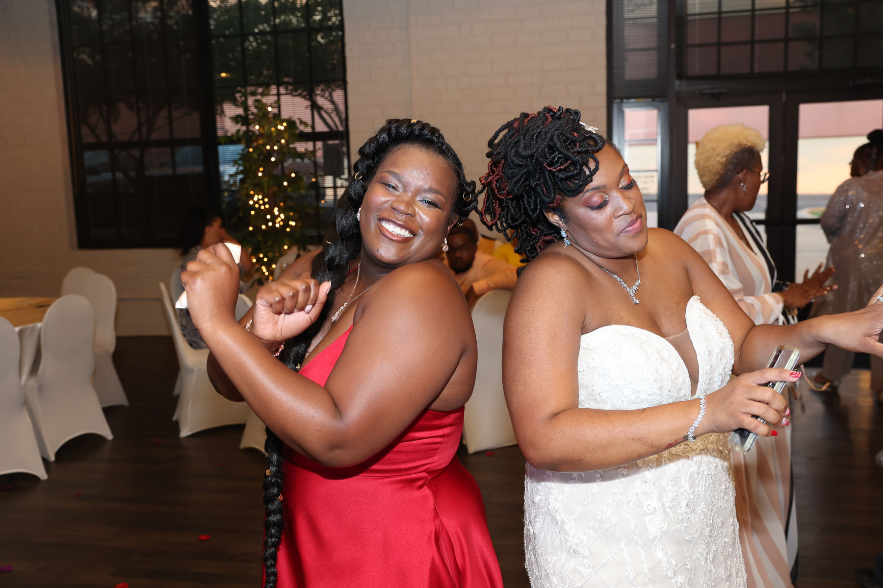 The bride and her bridesmaid dancing