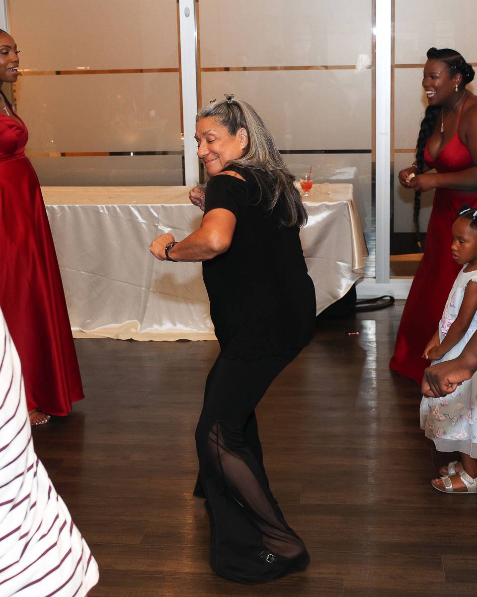 An old woman wearing an all-black outfit dancing