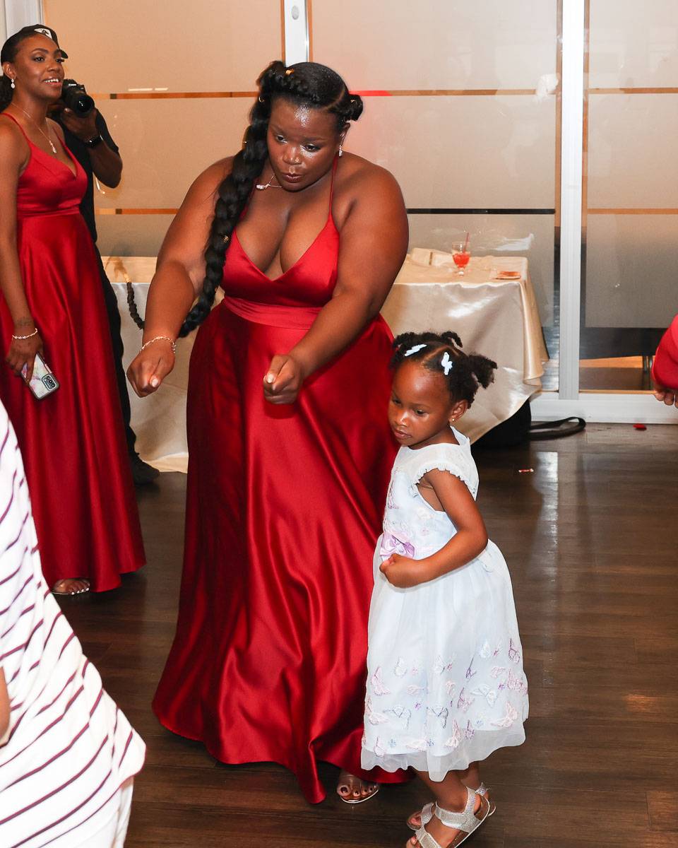 A bridesmaid dancing with a young girl