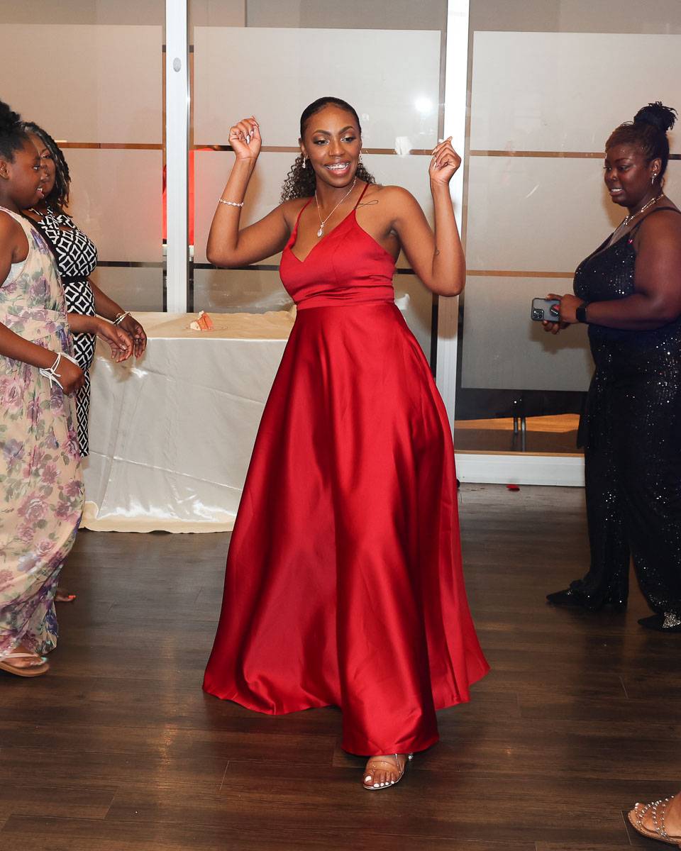 A bridesmaid swinging her hips as she moves forward
