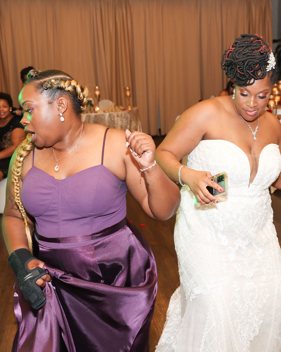 The bride dancing with her attendant