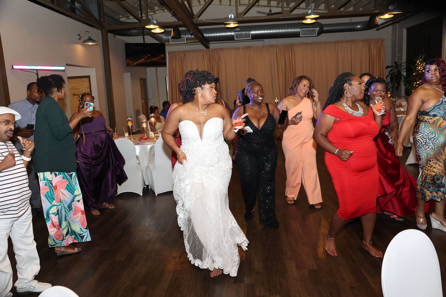 The bride and guests dancing in unison