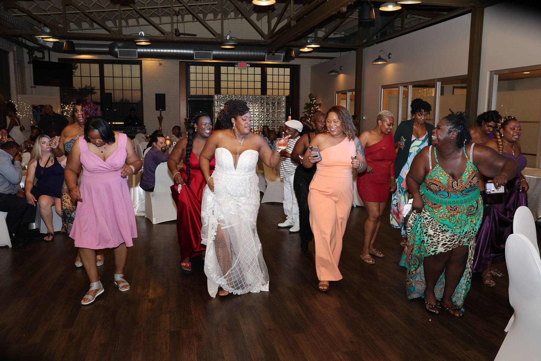 The bride dancing while holding a glass