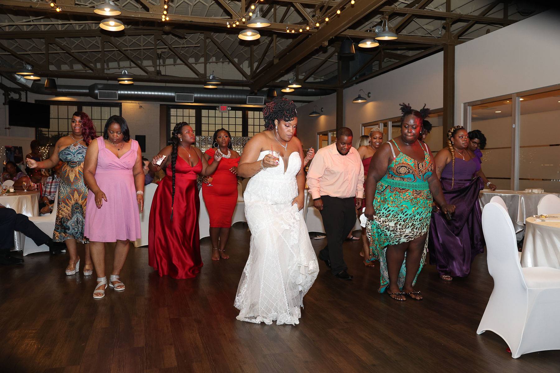 The bride and the guests dancing to the rhythm