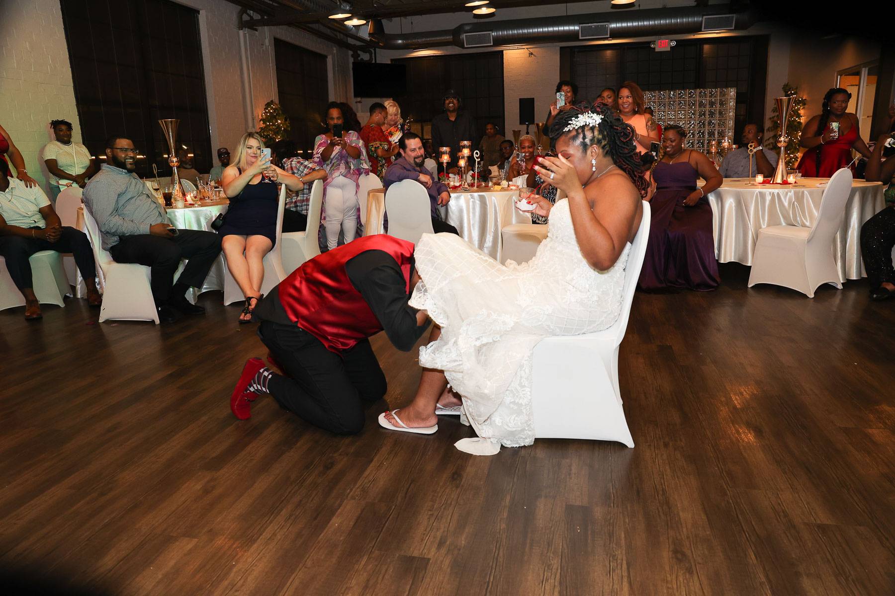 The groom looking inside the bride’s dress